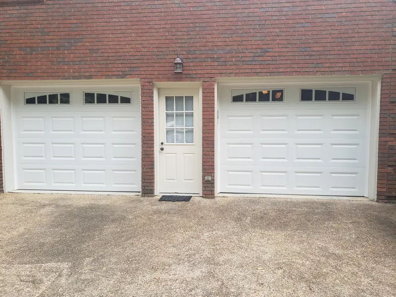 The same two openings with new white raised-panel doors